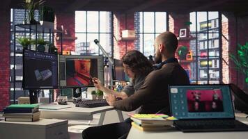 Man and woman work with app to develop a futuristic spaceship station. Neural network powered software uses automation and machine learning to generate game environments. Camera A. video