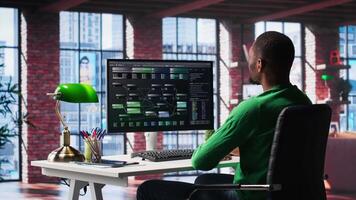 African american engineer at home working on visual coding on terminal window, typing programming language and reviewing the notes tree. IT expert using debugging algorithms to fix errors. Camera A. video