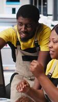 Vertical Black engineering team working at a high tech solar panel factory, reducing downtime and finetuning to a seamless production process. Technicians optimizing solar energy manufacturing. Camera A. video
