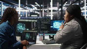 Data center engineering team deploying AI solutions optimizing gear. Server hub teamworking colleagues working together, using artificial intelligence to minimize systems downtime, camera A video