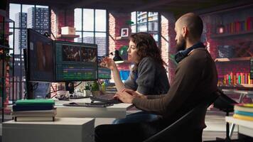 Creative couple working together on editing software for movie making, using AI powered models and prompts to create the perfect montage. Editors team in post production. Camera A. video
