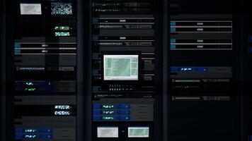 Server room computer overseeing gear delivering processing capacity for AI powered automation and database hosting. Central system controlling devices used for high speed data transfers, zoom out shot video