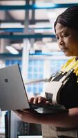 Vertical Photovoltaics factory technician designing CAD models and technical sketches for solar modules on laptop. Woman engineer ensures solar panel designs for efficiency and manufacturability. Camera A. video