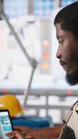 Vertical Black engineer develops power optimization models in solar panel production, working on PC software to increase renewable energy photovoltaic systems. Eco friendly industry. Camera A. video