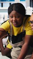 Vertical Black engineers collaborate on photovoltaic system designs at computer, focused on eco friendly renewable technology. Team finetuning solar power software and equipment performance. Camera B. video
