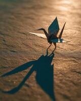 A paper crane is standing on the ground photo