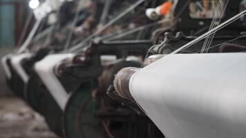 Observing the weaving process in a textile factory with spinning machinery video