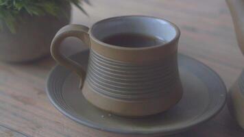 Enjoying herbal tea in a rustic setting with handmade pottery video