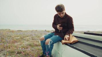 Christian Man Reading A Prayer On The Bible Book While On The Beach video