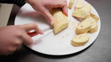 In a Home Kitchen A Woman Cuts Cantucci Biscuits Before Second Baking In Oven video