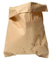 Crumpled brown paper bag with visible grease stains, standing upright on isolated background. photo