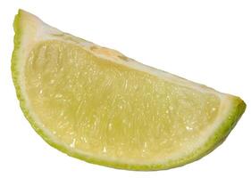 Close-up of a fresh lime wedge with juicy pulp and a bright green peel, isolated background photo