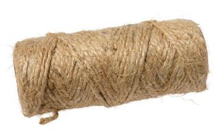 A tightly wound spool of rustic, light brown jute twine with visible fibers, isolated background photo