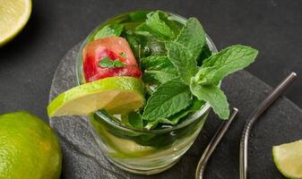 Refreshing mojito cocktail with lime, mint, strawberry, and ice photo