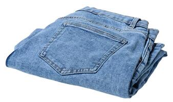 Folded pair of light blue denim jeans, isolated background photo