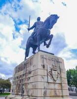 BATALHA, PORTUGAL - JUNE 10, 2023 Equestrian statue depicting a historical figure with sword against cloudy sky. Editorial use for history, travel, and cultural articles. photo