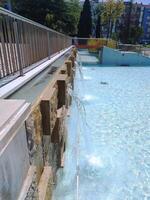 ALCOBACA, PORTUGAL - APRIL 27, 2025 Modern water feature with cascading streams and stone accents. Serene public space. Suitable for travel or architectural editorials. photo