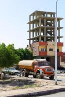 SHARM EL SHEIKH, EGYPT - JUNE 01, 2017 Construction site and water truck in developing world. Illustrates infrastructure, development, and daily life. Editorial use. photo