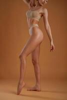 Showing the ,,side, standing. Woman ,with slim body shape is posing against background photo