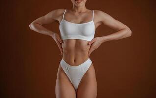 Front view. Woman with ,,slim body shape, is posing against background photo