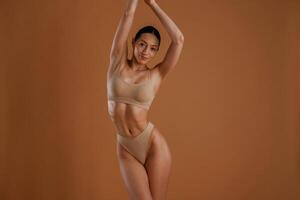 Beautiful model. Woman with slim,, body, shape is posing against background photo