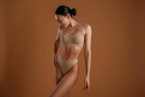 Fitness slim body ,shape. Woman is posing against background photo