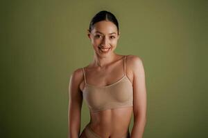 Smiling, cheerful ,facial, expression. Woman with slim body shape is posing against background photo