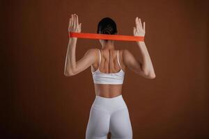 Stretching the hands. ,Beautiful fitness woman is in the studio photo