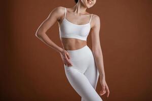 Female, front ,view, smiling. Beautiful fitness woman is in the studio photo