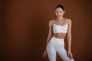 Female, front view,,, smiling. Beautiful fitness woman is in the studio photo