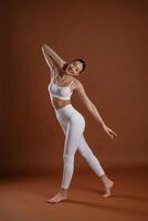 Female, front view, smiling. Beautiful,, fitness woman is in the studio photo