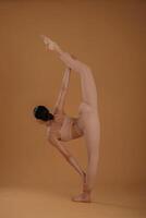 Side, view, doing exercise for legs and hands. Beautiful fitness woman is in the studio photo