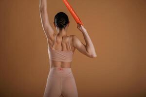 Cloth for, stretching hands. Beautiful fitness woman is in the studio photo