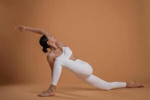 Doing stretching exercises.,. Beautiful fitness woman is in the studio photo