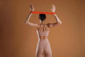 Cloth,, for stretching hands. Beautiful fitness woman is in the studio photo