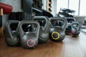 Bunch of weights for workout on the wooden floor in the gym photo