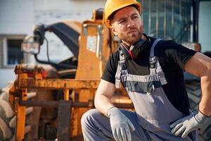 Man,, ,is with tractor. Agricultural worker. photo