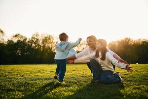 Mother,, with daughter and son are together on the field photo