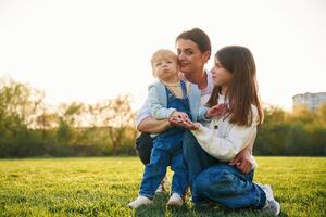 Mother, with daughter and son are together on the field photo