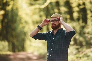 Bearded man, is, in the forest at daytime photo