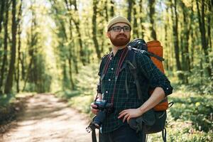 Front view. ,,Bearded man is in the forest at daytime photo