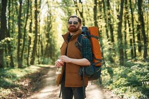 Enjoying warm weather and nature.. Bearded man is in the forest at daytime photo