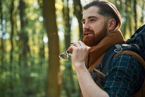 Bearded ,man is in the forest at daytime photo