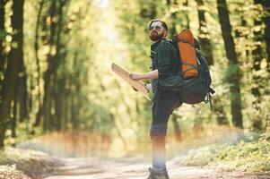 Colorful lens, effect.. Bearded man is in the forest at daytime photo
