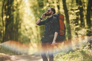 Colorful lens ,effect. Bearded man is in the forest at daytime photo