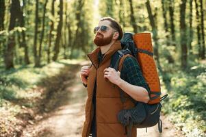 Bearded, man is in the forest at daytime photo