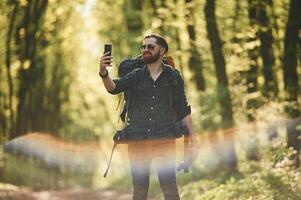 Colorful,,, lens effect. Bearded man is in the forest at daytime photo
