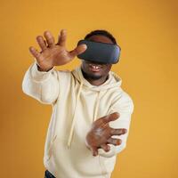 Virtual reality experience... Black guy is against yellow background photo