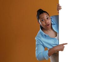 Copy space in white color. African American,, woman is in the studio against yellow background photo
