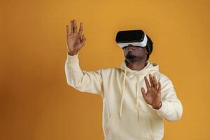 Playing VR game. In virtual, reality ,glasses. Black guy is against yellow background photo
